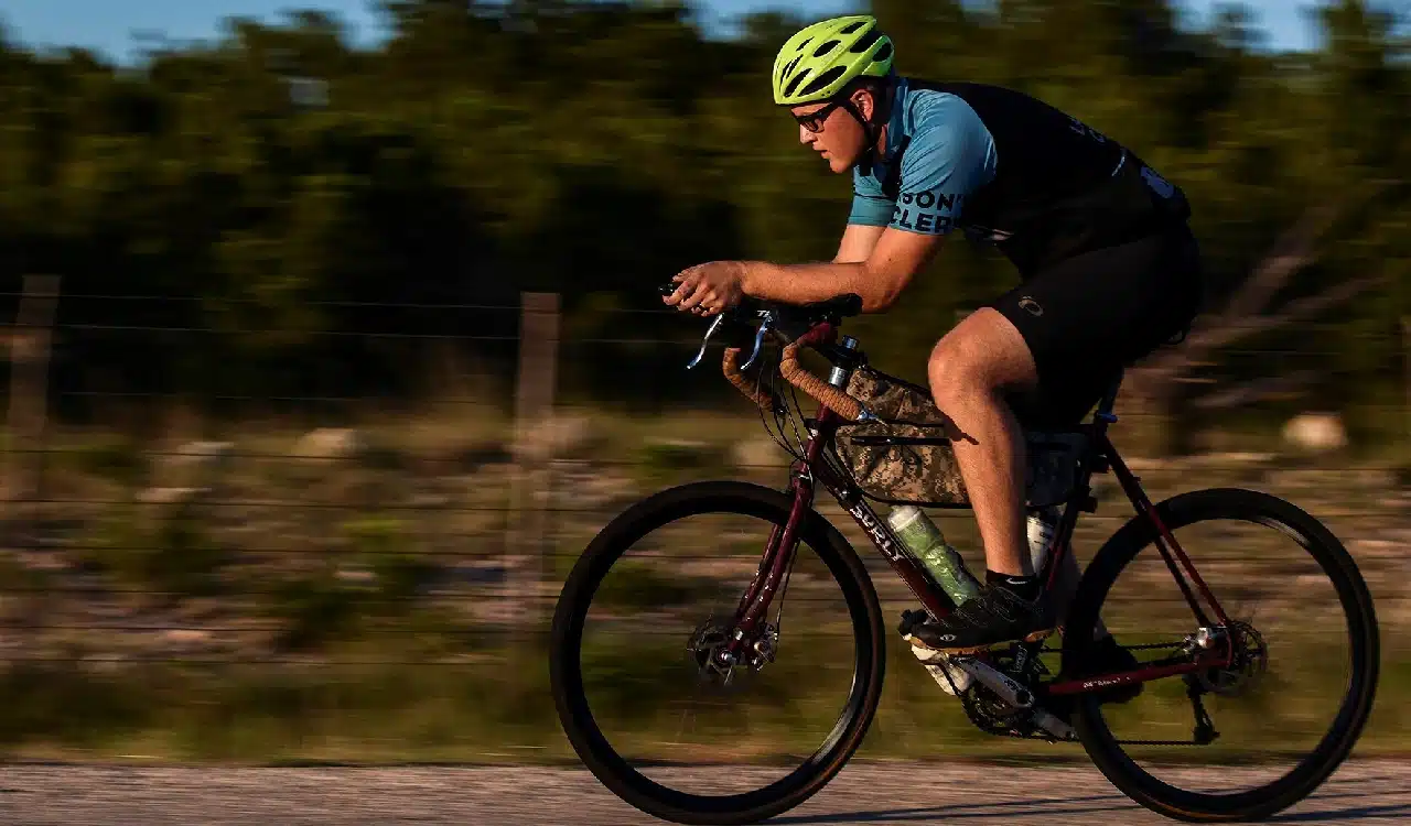 Cyclist Riding Road Bike Outdoors at Sunset Cyclist Riding Road Bike Outdoors at Sunset
