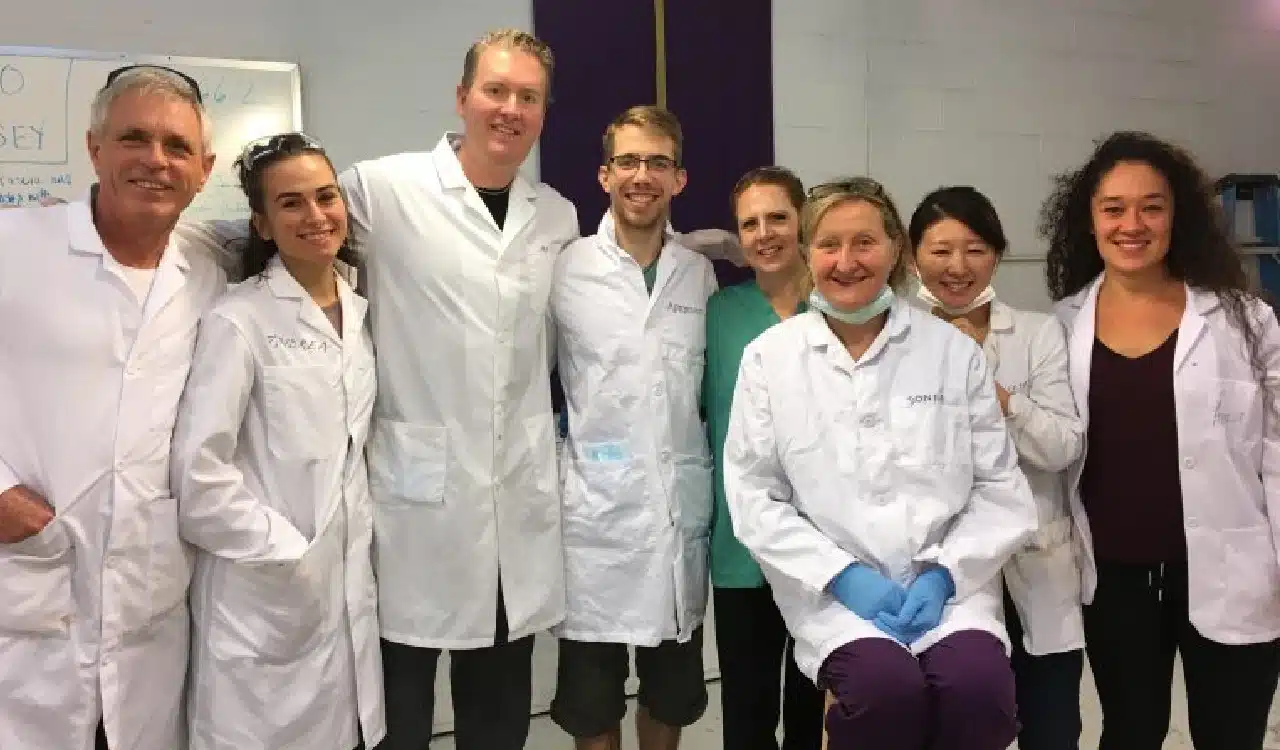 Group of Scientists in Lab Coats Smiling Together Group of Scientists in Lab Coats Smiling Together