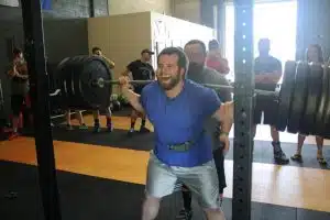 Powerlifting Squat Attempt with Spotter at the Gym