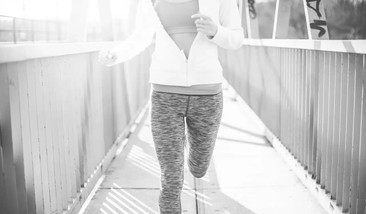 Woman Jogging on a Bridge in Activewear Woman Jogging on a Bridge in Activewear